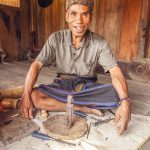 A wood carver at the Wologai traditional village